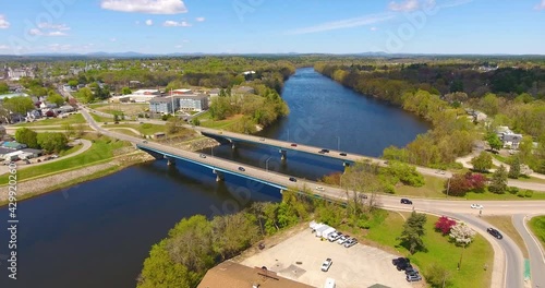 Flying on Merrimack River and Taylor Falls Bridge between town of Hudson and city of Nashua in spring in New Hampshire, NH, USA.  photo