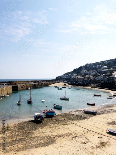 Historic fishing port in England with blue sky and turquoise water