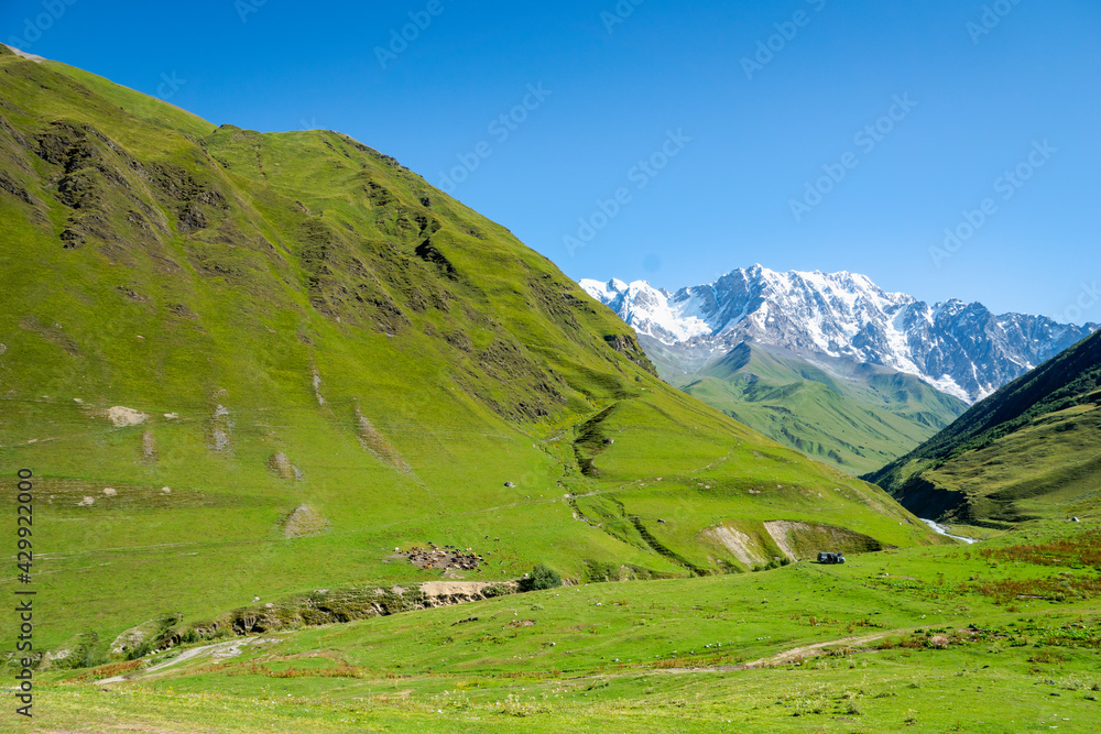 idyllic alpine landscape with mountain for hiking and trekking with copy space, in countryside of Ushguli village with in Upper Svaneti region, Georgia.