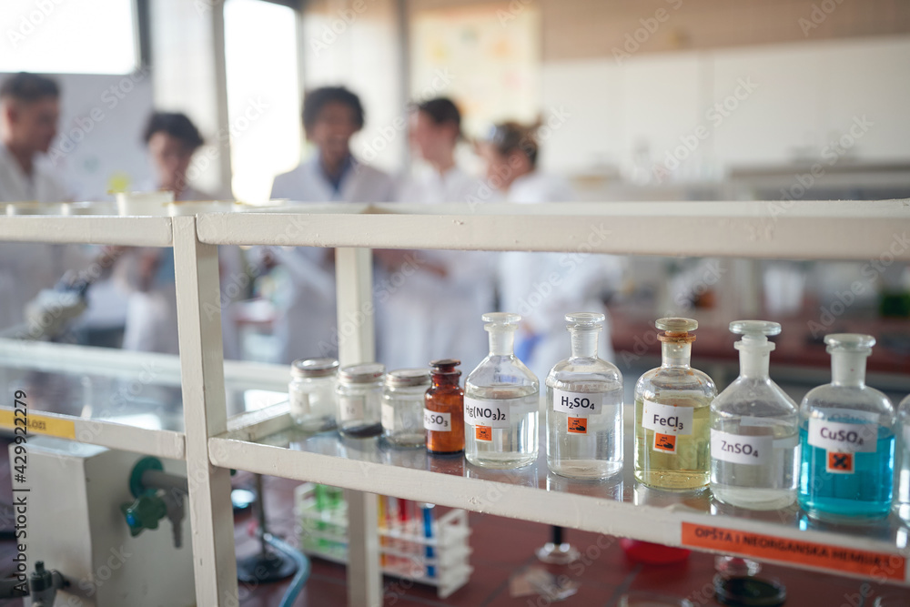 Young chemistry students preparing for a work in the university laboratory. Science, chemistry, lab, people