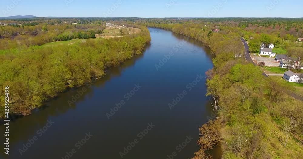 Flying on Merrimack River between town of Litchfield and Merrimack in spring in town center of Litchfield, New Hampshire, NH, USA. Flying on Merrimack River between town of Litchfield and Merrimack in spring in town center of Litchfield, New Hampshire, NH, USA.