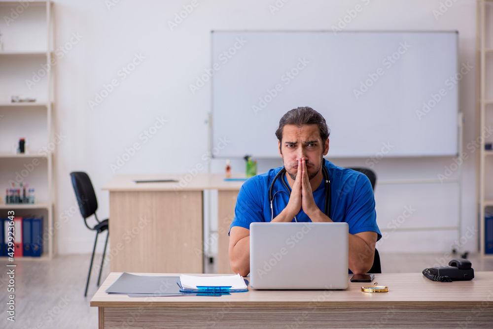 Young male doctor working in the clinic Young male doctor working in the clinic