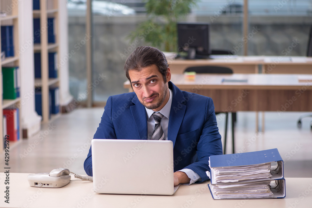 Fototapeta premium Young male employee working in the office