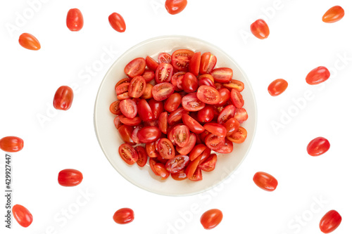 tomatoes cherry on plate on a table with white background as composition