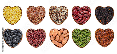 Collection of colorful cereal and grain seeds in heart shape wooden box isolated on white background consisted of mung bean, rice, quinoa, red and black bean, and almond