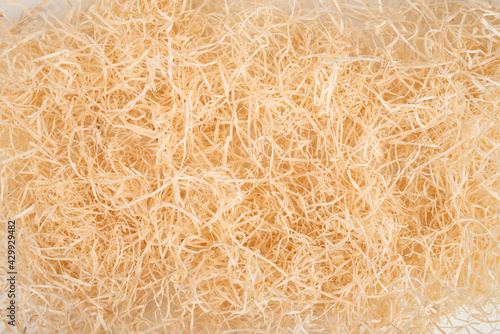 packing wood shavings chips yellow thin recycled paper box carton closeup