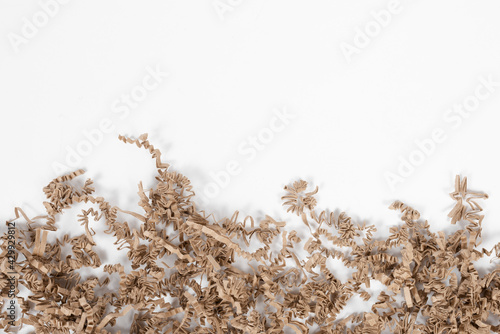packing wood shavings chips on white background, carton, recycled, paper