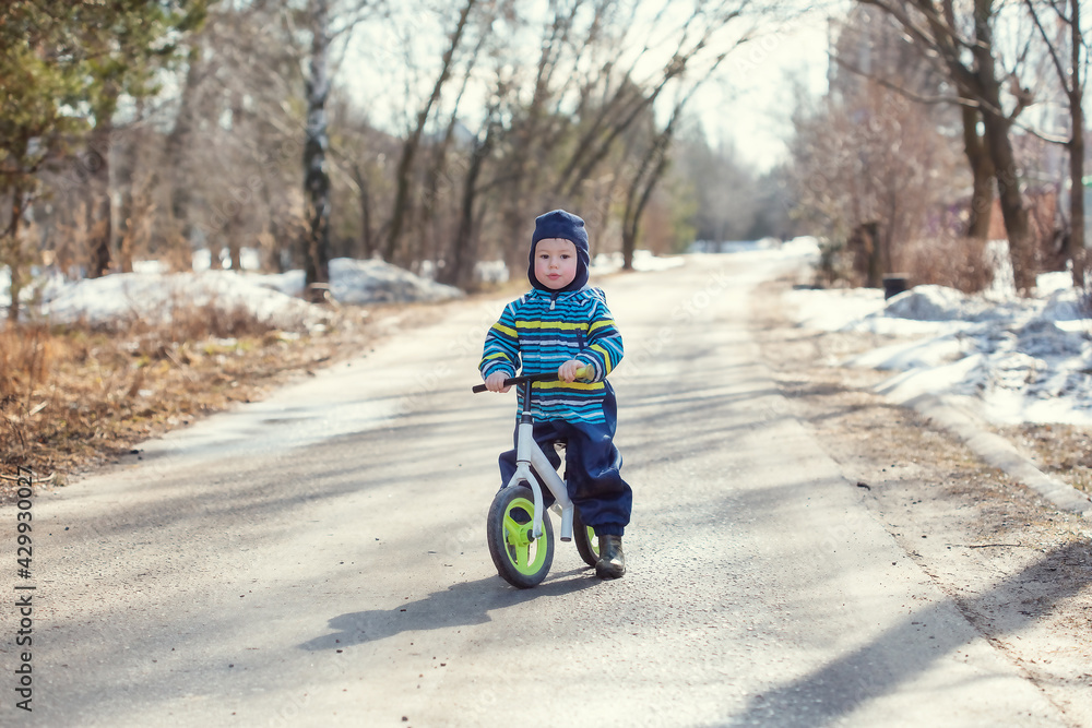 A little Caucasian boy 2 years old learns to ride a balance bike A little Caucasian boy 2 years old learns to ride a balance bike