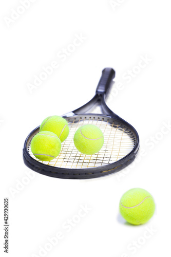 tennis racket with yellow balls on white background. Sport concept. © Aida Servi