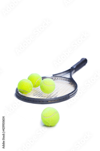 tennis racket with yellow balls on white background. Sport concept.