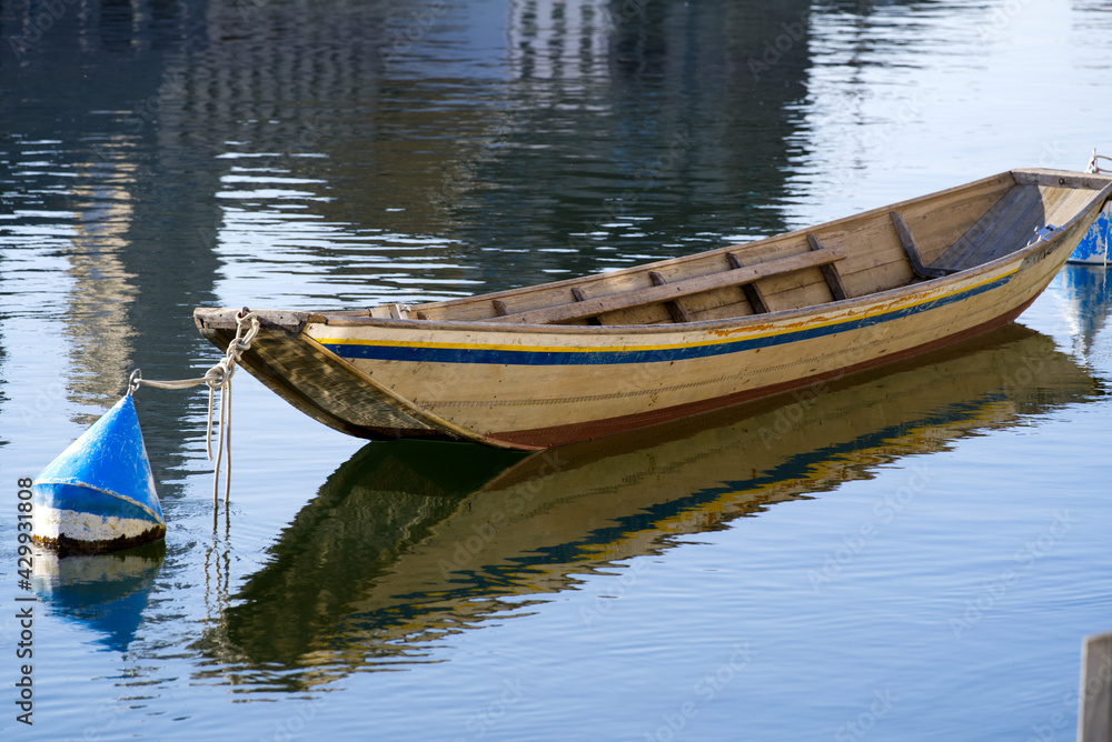 Wooden boat on river Limmat in the morning at springtime. Photo taken April 23rd, 2021, Zurich, Switzerland. Wooden boat on river Limmat in the morning at springtime. Photo taken April 23rd, 2021, Zurich, Switzerland.