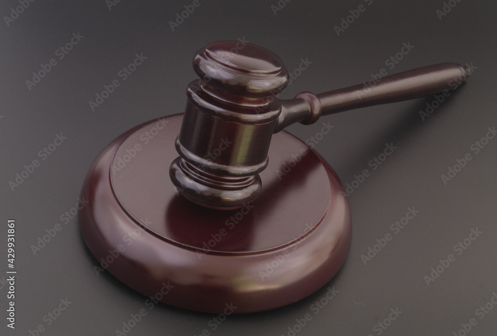 Wooden judge gavel on black table close up, legal and law concept. Wooden judge gavel on black table close up, legal and law concept.