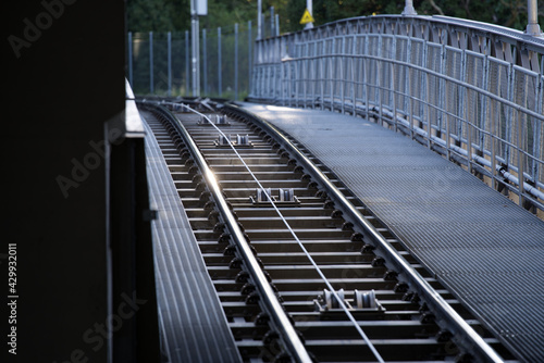 Fototapeta Naklejka Na Ścianę i Meble -  Tracks of cable car station at City of Zurich early in the morning at springtime. with sunbeams and backlight. Photo taken April 23rd, 2021, Zurich, Switzerland.