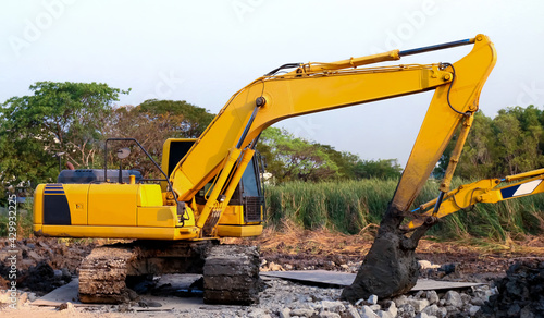 backhoe  backhoe tractor yellow dig scoop at construction site