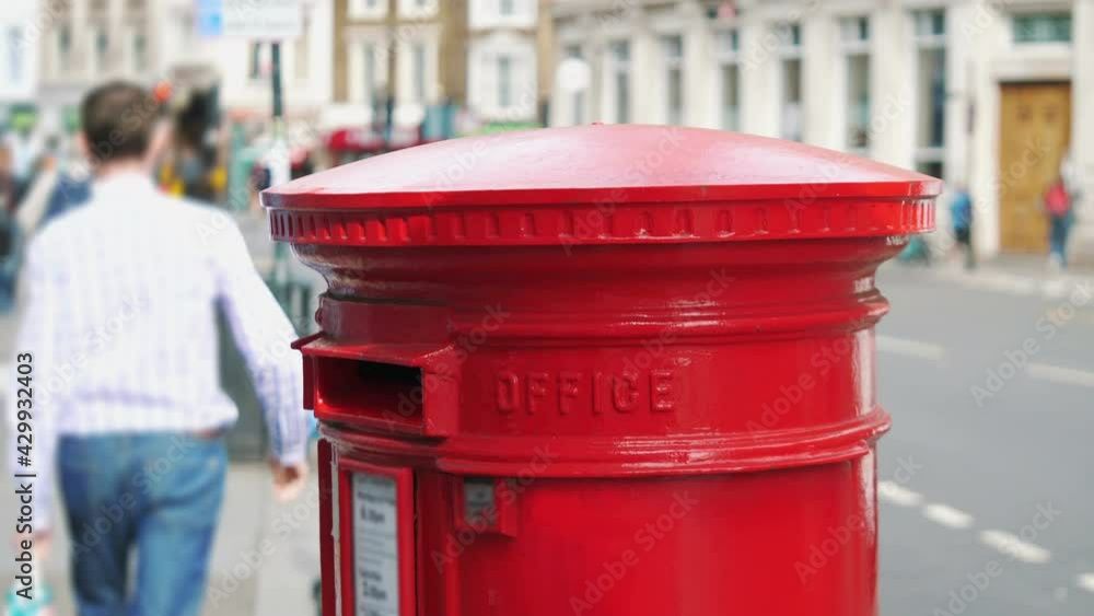 Red mailbox in London city street in 4k slow motion 60fps Red mailbox in London city street in 4k slow motion 60fps