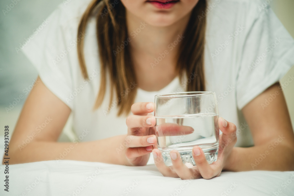 girl with a glass of water on the bed girl with a glass of water on the bed