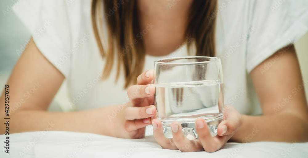 a glass of water in hands close-up a glass of water in hands close-up