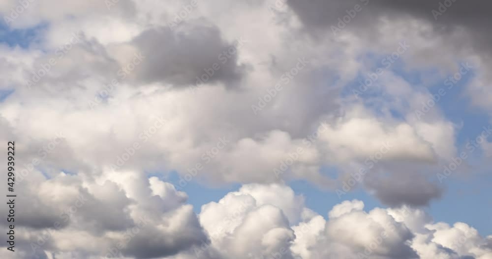 Time lapse clip of several fluffy curly rolling cloud layers in windy weather at overcast sky Time lapse clip of several fluffy curly rolling cloud layers in windy weather at overcast sky