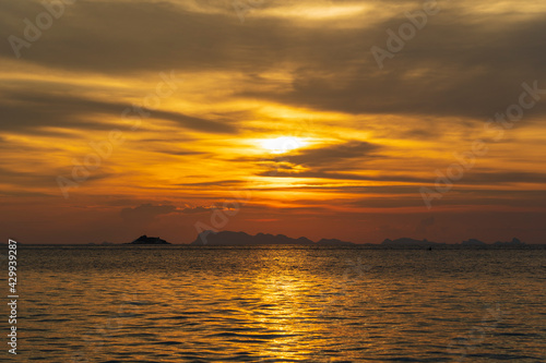 Beautiful sunset over the sea water on the island of Koh Phangan, Thailand © OlegD