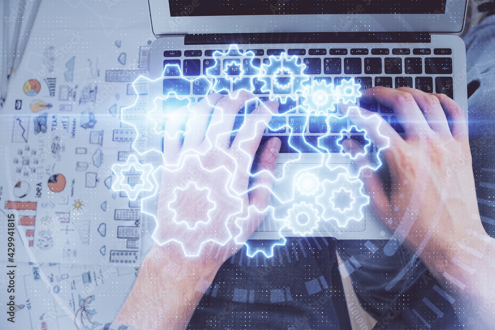 Double exposure of man's hands typing over computer keyboard and business theme hologram drawing. Top view. Financial markets concept. Double exposure of man's hands typing over computer keyboard and business theme hologram drawing. Top view. Financial markets concept.