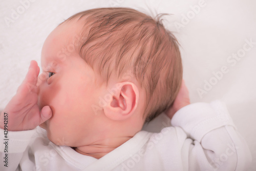 Close up beautiful sleeping newborn baby. Detail view at cute baby face.