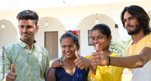 Canvas Print Group of young Indian people with their thumbs up being photographed
