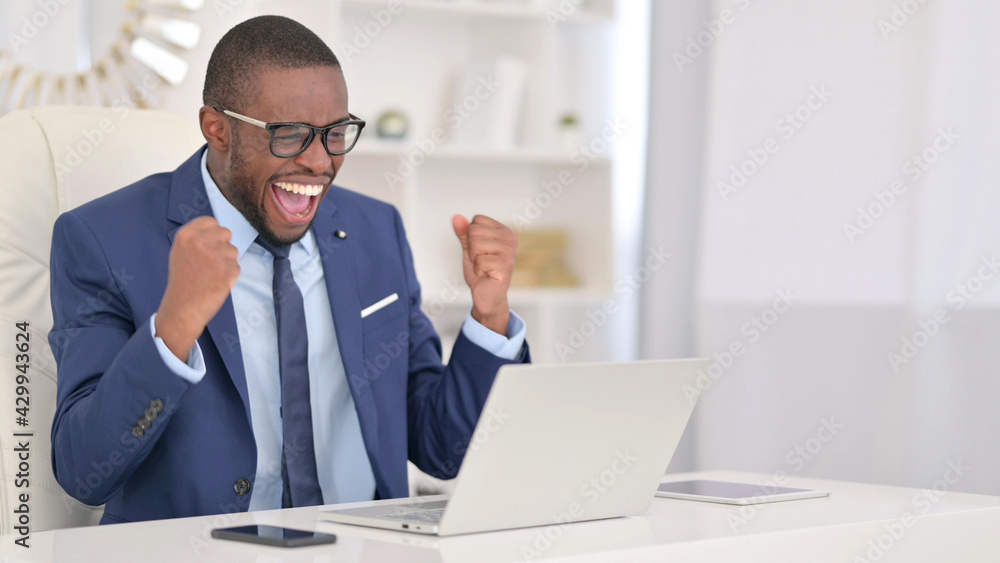 Winning, African Businessman Celebrating Success on Laptop Winning, African Businessman Celebrating Success on Laptop
