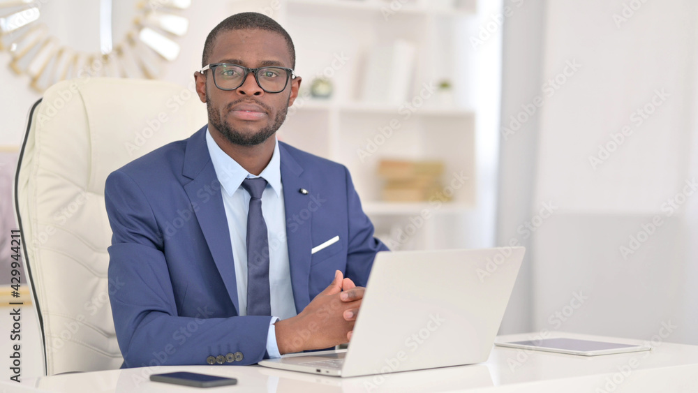 Young African Businessman with Laptop Looking at the Camera Young African Businessman with Laptop Looking at the Camera