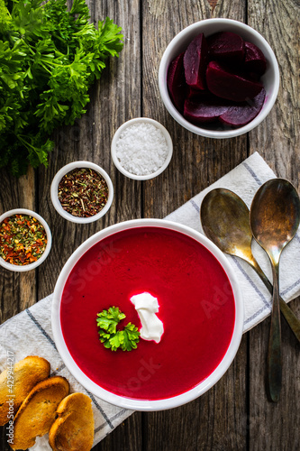 Beetroots cream soup on wooden table
