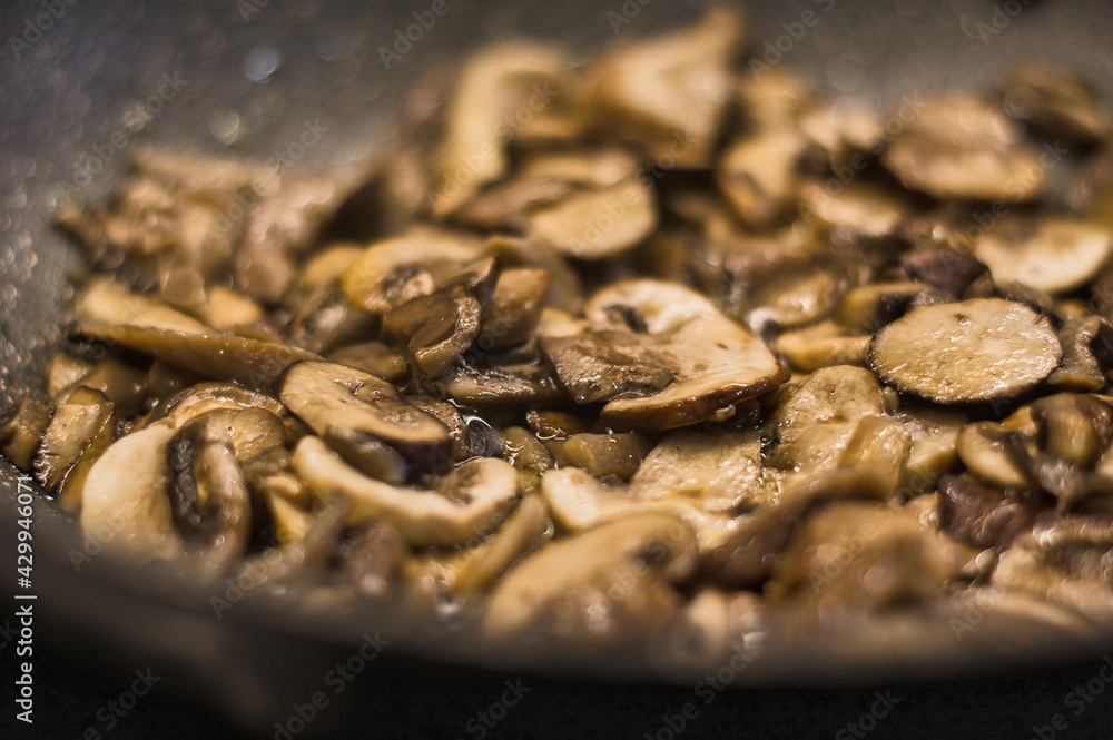Desenfoque selectivo de setas y champiñones cocinándose en una sartén con aceite de oliva. Desenfoque selectivo de setas y champiñones cocinándose en una sartén con aceite de oliva.