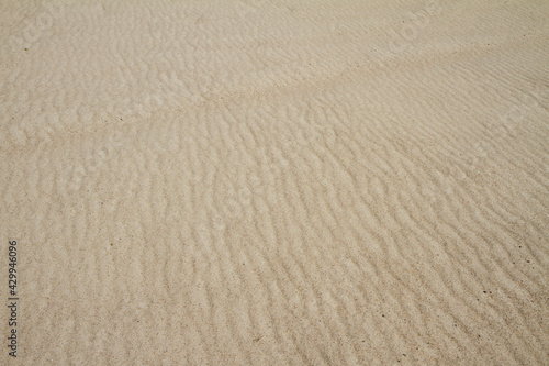 Dunes created on river bank. Sand texture. 