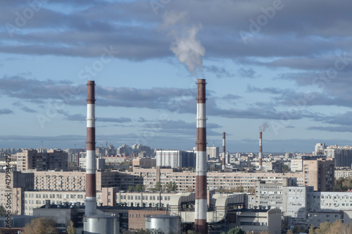 industrial city pipes sun clouds