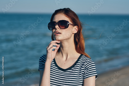 nature landscape woman near the sea on the beach in sunglasses