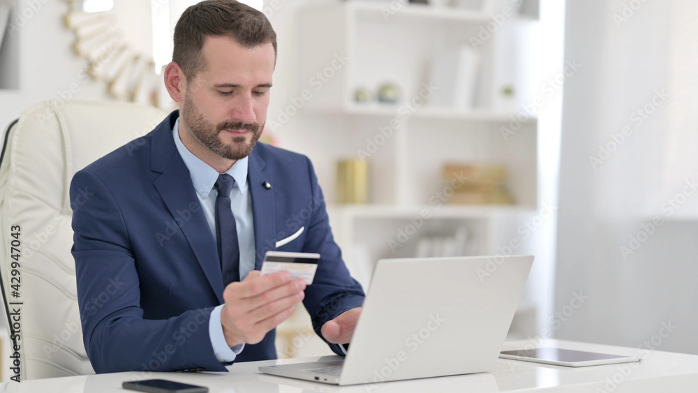 Cheerful Designer making Successful Online Payment on Smartphone Cheerful Designer making Successful Online Payment on Smartphone