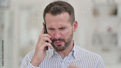 Portrait of Angry Young Man Arguing on Smartphone 
