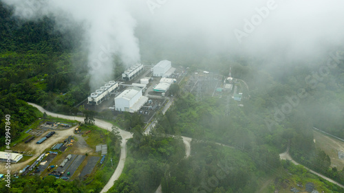 Aerial drone of Geotermal power plant on Mount Apo. Geothermal station with steam and pipes in the rainforest. Mindanao, Philippines.