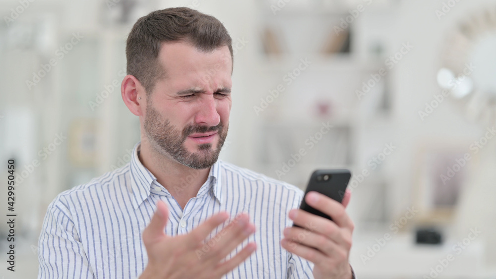 Portrait of Upset Young Man having Loss on Smartphone Portrait of Upset Young Man having Loss on Smartphone