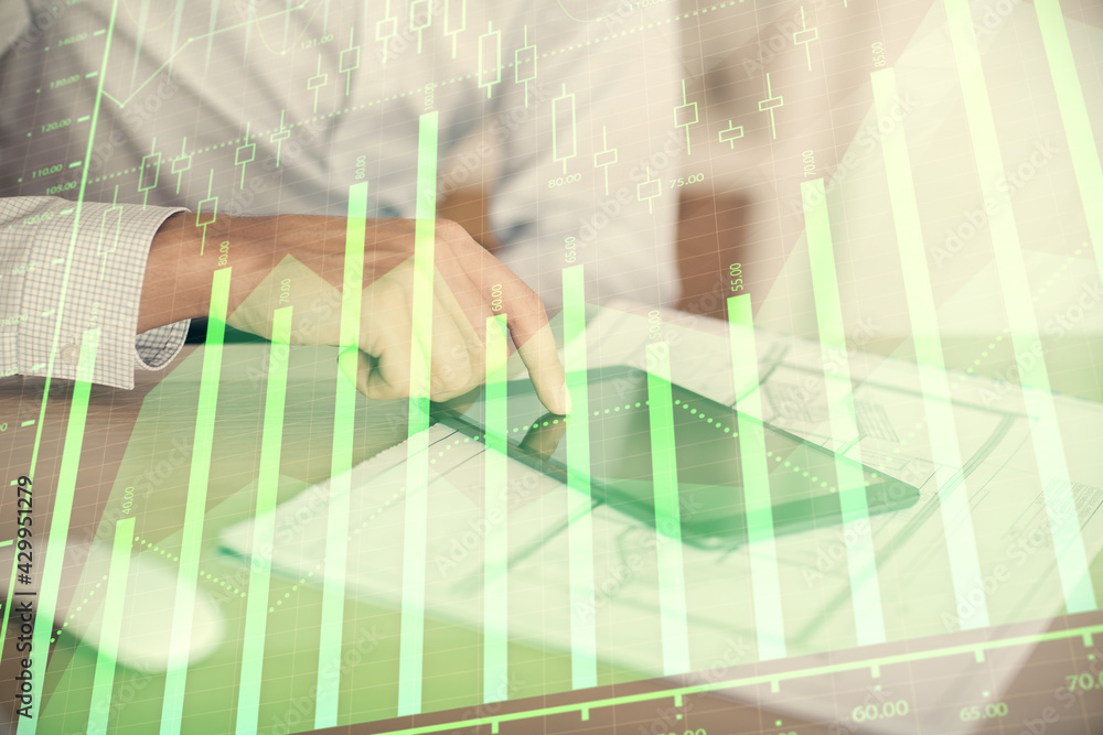 Fototapeta premium Double exposure of man's hands holding and using a digital device and forex graph drawing. Financial market concept.