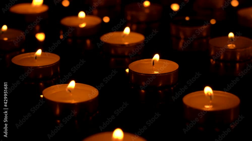 Candles are burning on a black background Candles are burning on a black background