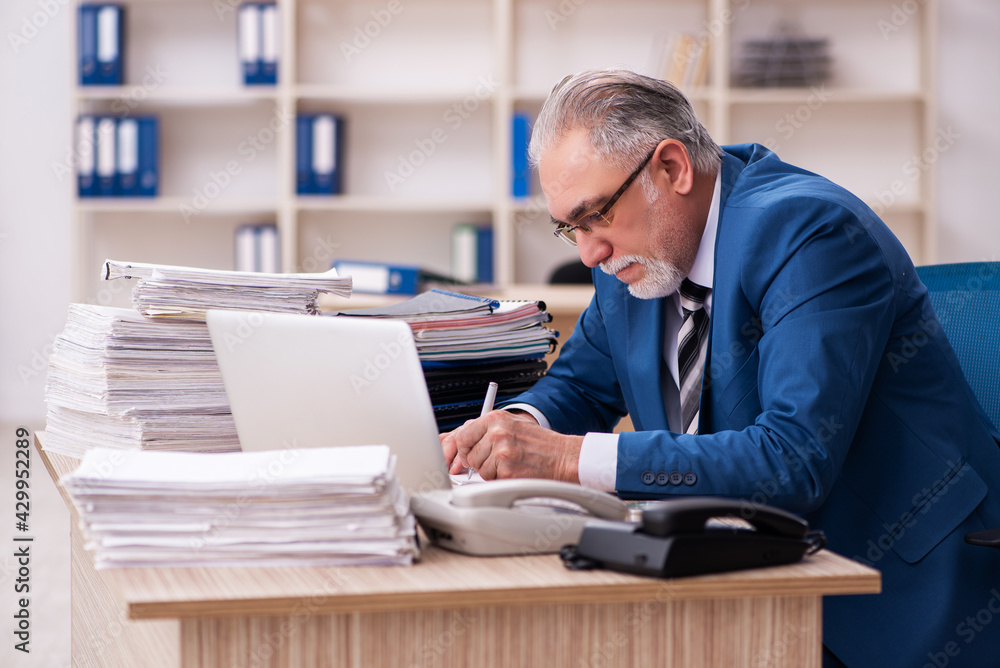 Old male employee and too much work in the office Old male employee and too much work in the office