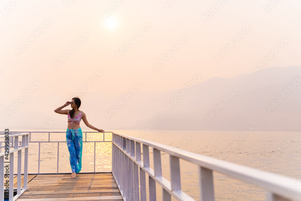 Fototapeta premium Summer lifestyle tropical beach vacation. Happy traveller asian woman with tanned in swimwear at&nbsp;Beach