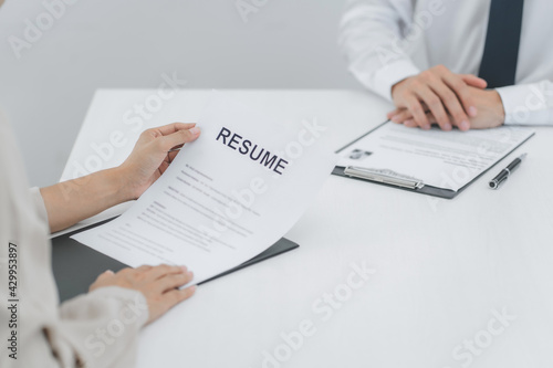 Successful job interview, Recruiter or manager and job candidate with resume in office.