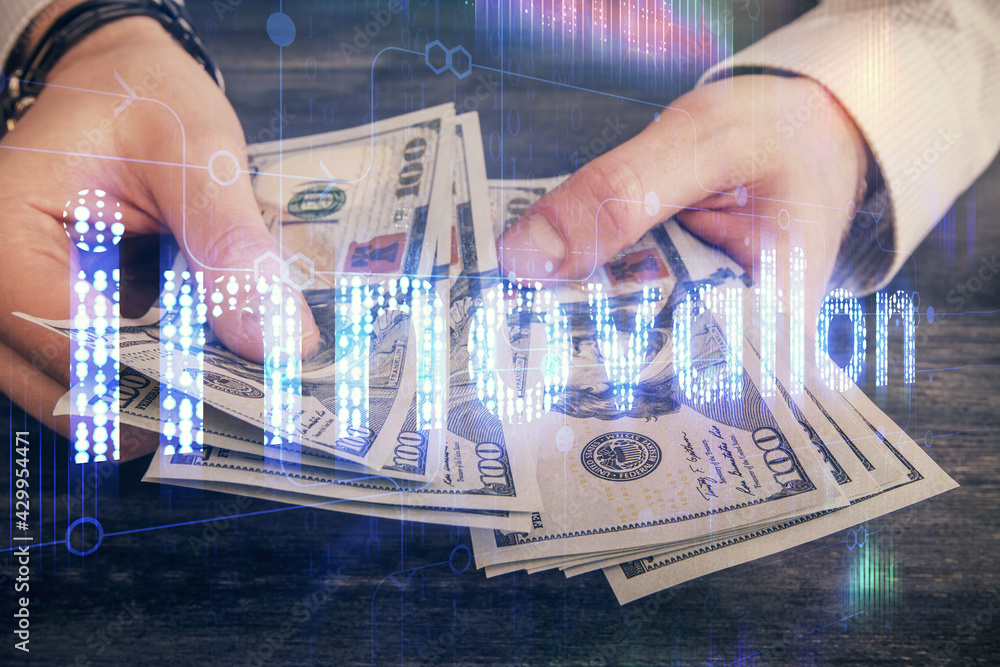 Multi exposure of technology drawing hologram and us dollars bills and man hands. Data concept Multi exposure of technology drawing hologram and us dollars bills and man hands. Data concept
