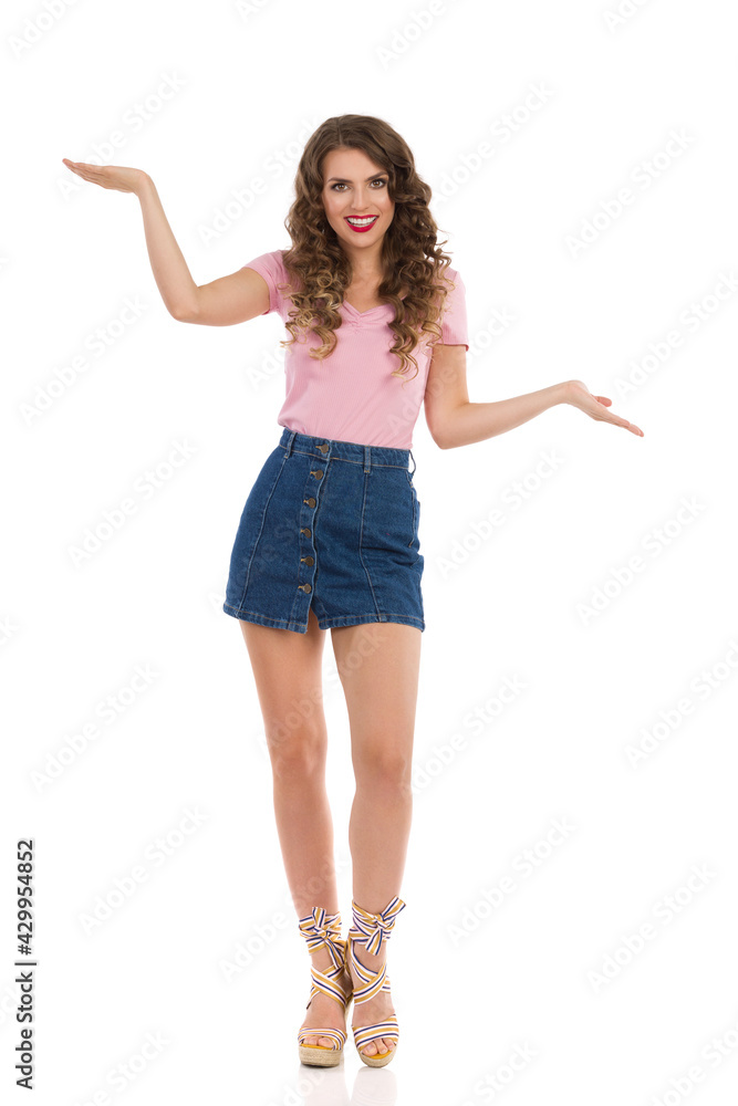 Beautiful Young Woman In Jeans Mini Skirt Is Standing With Hands Raised Beautiful Young Woman In Jeans Mini Skirt Is Standing With Hands Raised