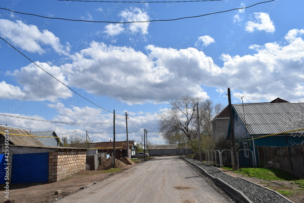 Clouds in the blue sky above the village