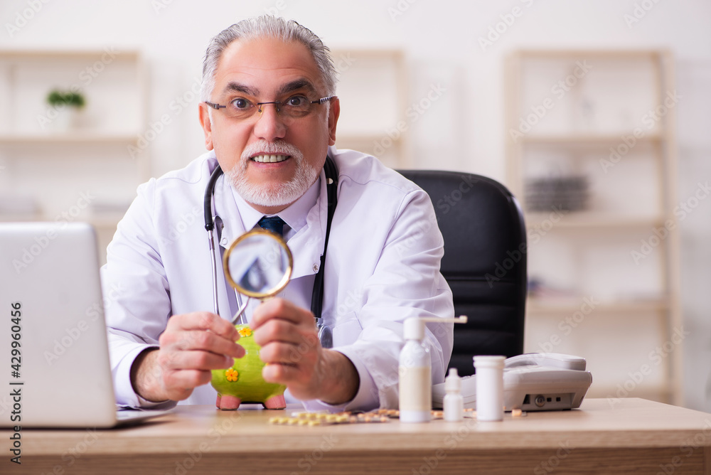 Experienced male doctor in remuneration concept Experienced male doctor in remuneration concept