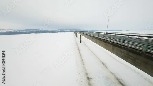 Aerial View, Flying Under Mjosa Bridge in Norway, FPV Drone View photo