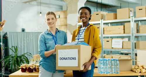 Tableau sur toile Young mixed-race happy warehouse workers volunteers working in shipping delivery