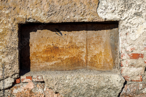 an old stone wall with a deepening rectangular shape photo