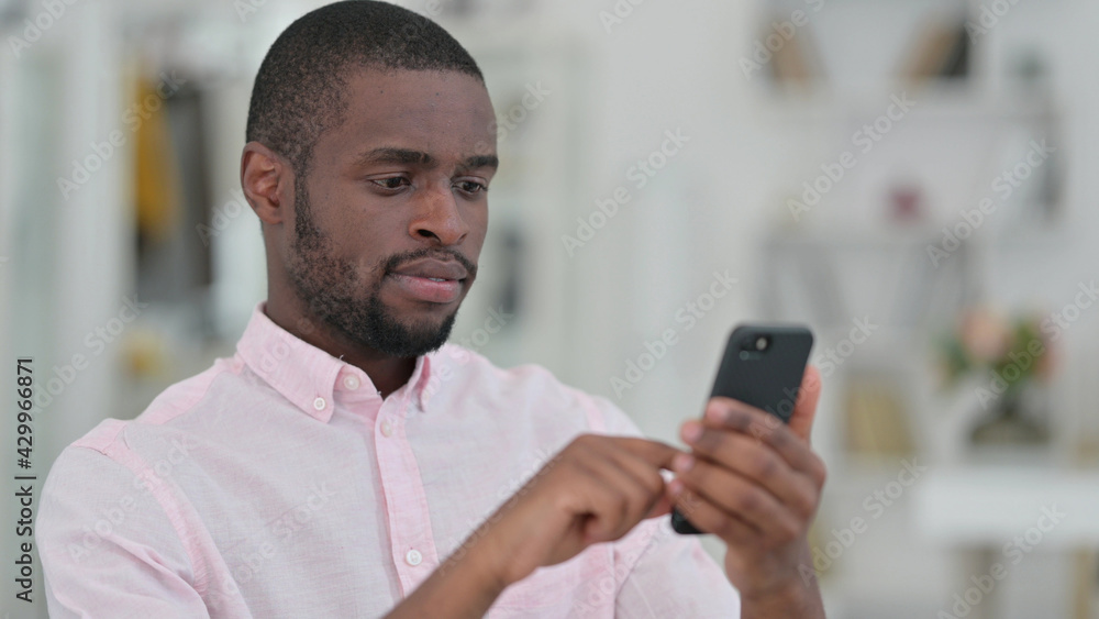 Portrait of Serious African Man using Smartphone Portrait of Serious African Man using Smartphone